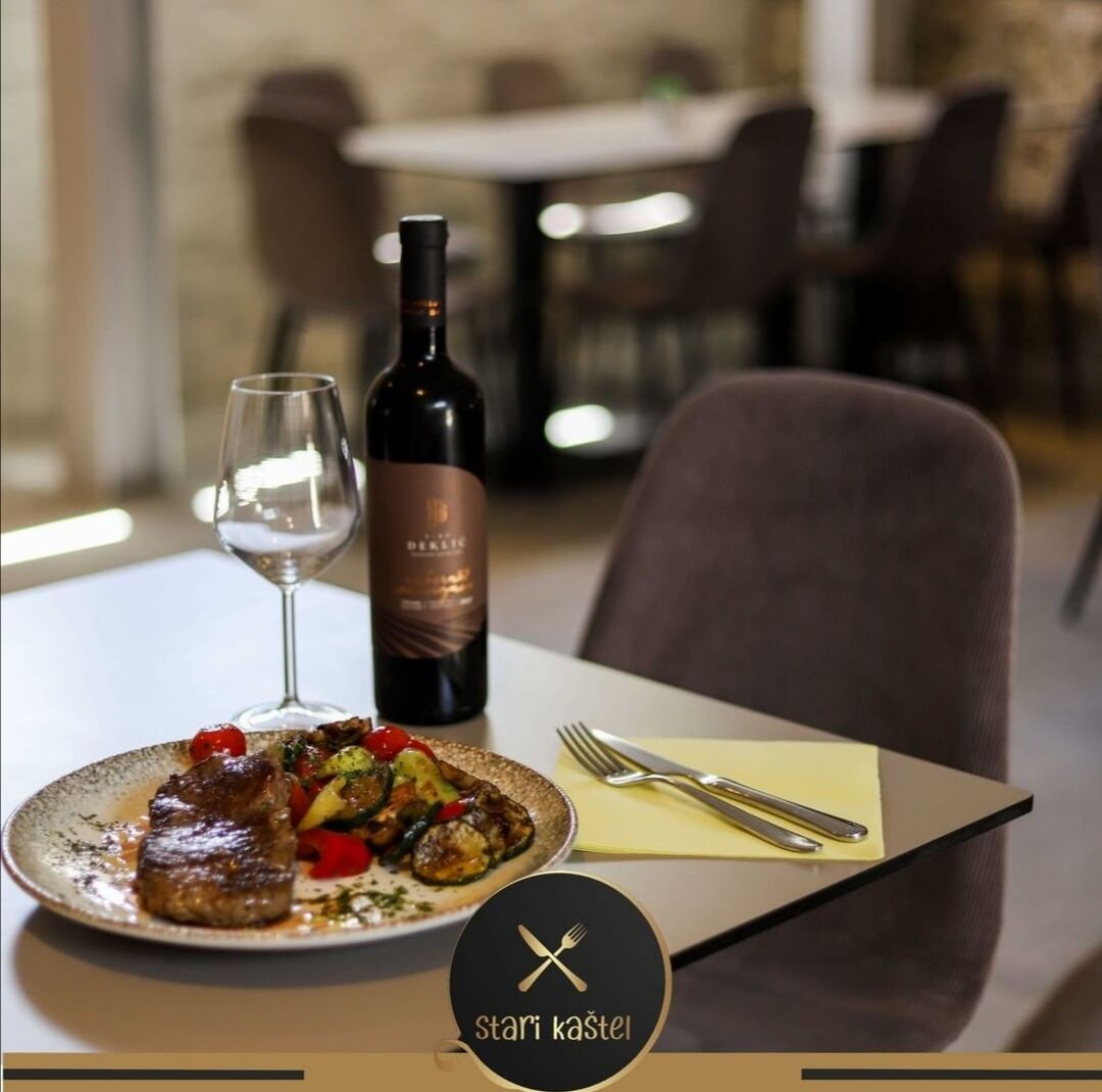 Bistro Stari Kaštel interior with stone wall and ambient lighting, Novalja
